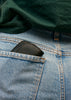 Ida leather pouch shown sticking out of back pocket of woman's jeans.